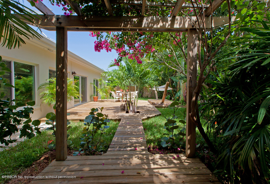130 Alpine Road West Palm Beach, FL 33405 - Photo 9 of 14 a front view of a house with garden
