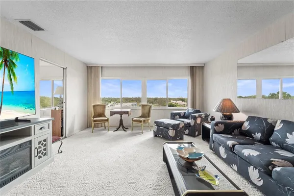 a living room with furniture and a lamp