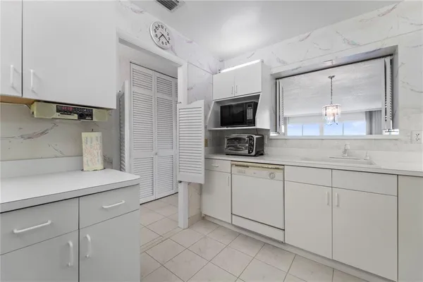 a utility room with cabinets washer and dryer