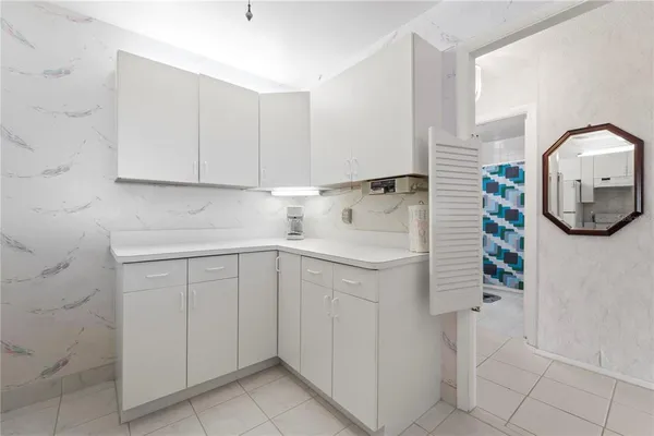 a white refrigerator freezer sitting inside of a kitchen
