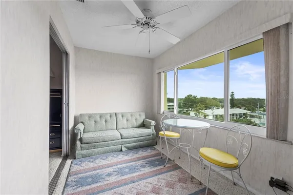 a view of a livingroom with furniture and a window