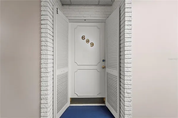 a view of walk in closet with wooden floor