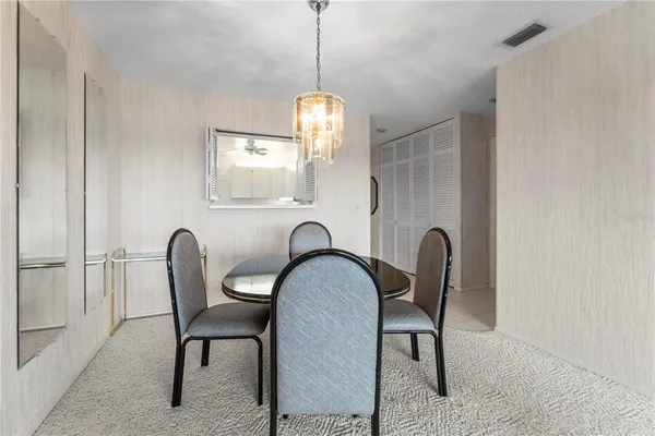 a dining room filled with furniture and a chandelier