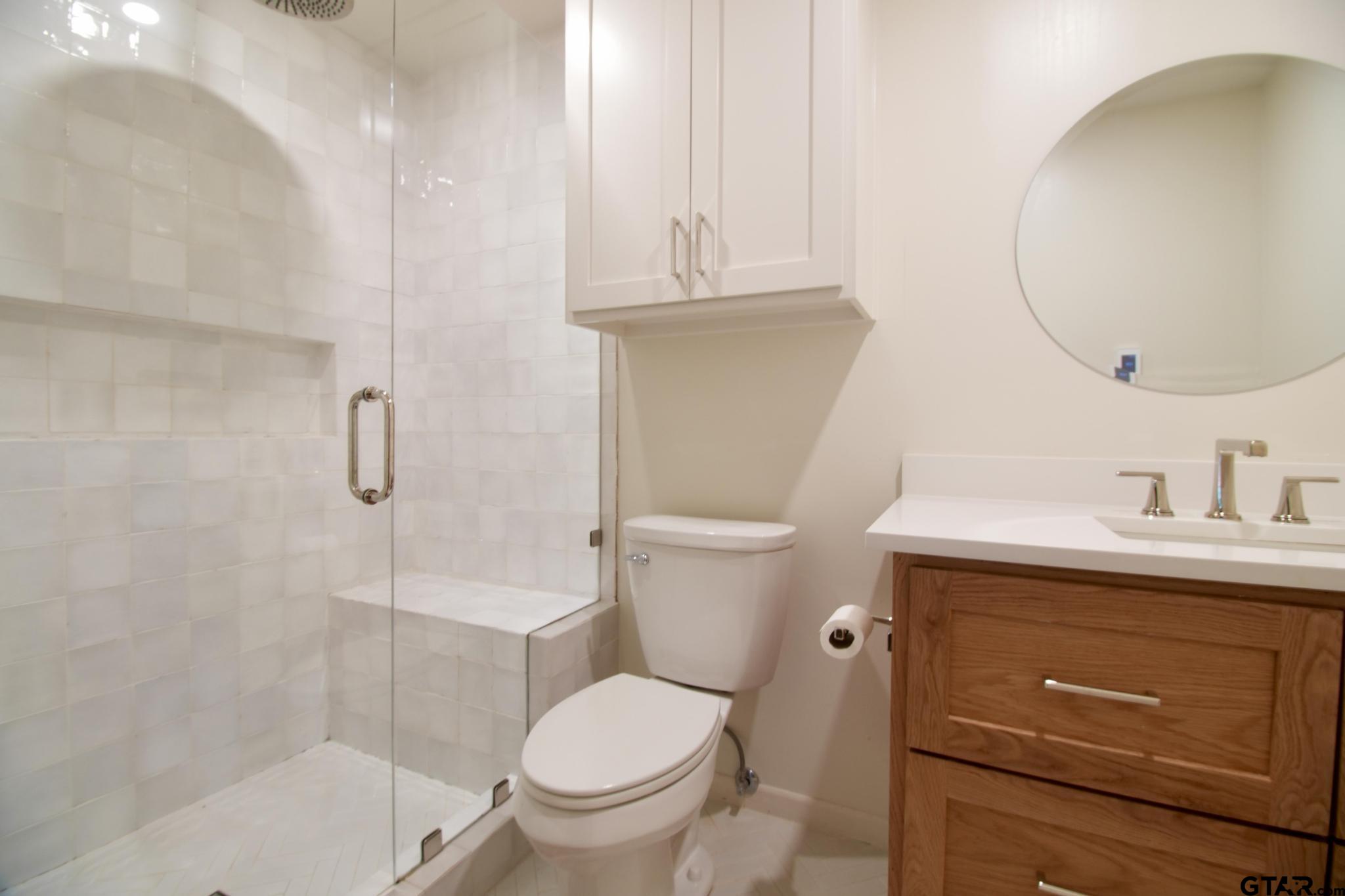 18392 Eastside Road Troup, TX 75789 - Photo 12 of 19 a bathroom with a sink a toilet and a mirror