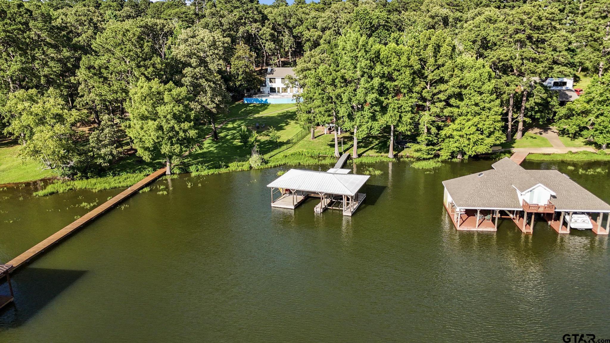 18392 Eastside Road Troup, TX 75789 - Photo 16 of 19 a view of a lake with table and chairs