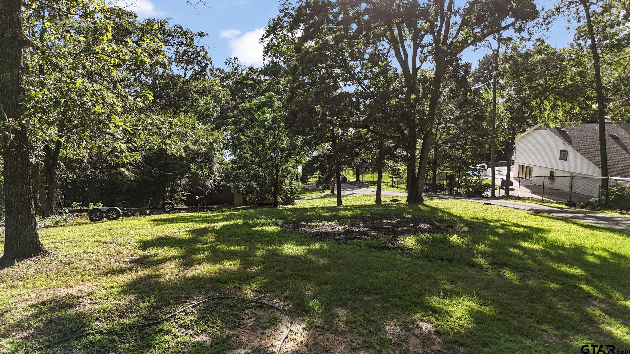 18392 Eastside Road Troup, TX 75789 - Photo 19 of 19 a backyard of a house with a large tree