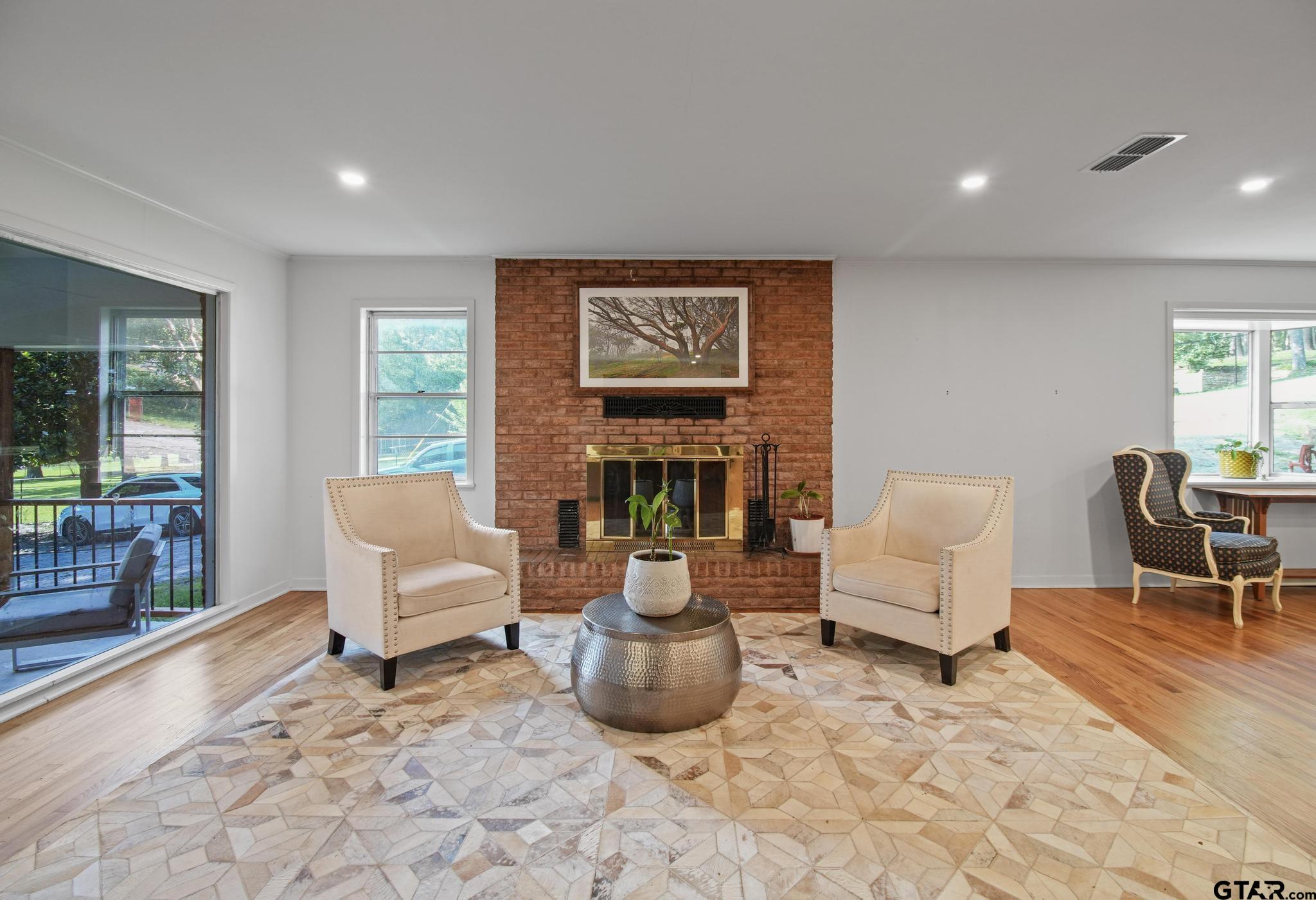 18392 Eastside Road Troup, TX 75789 - Photo 9 of 19 a living room with furniture and a fireplace