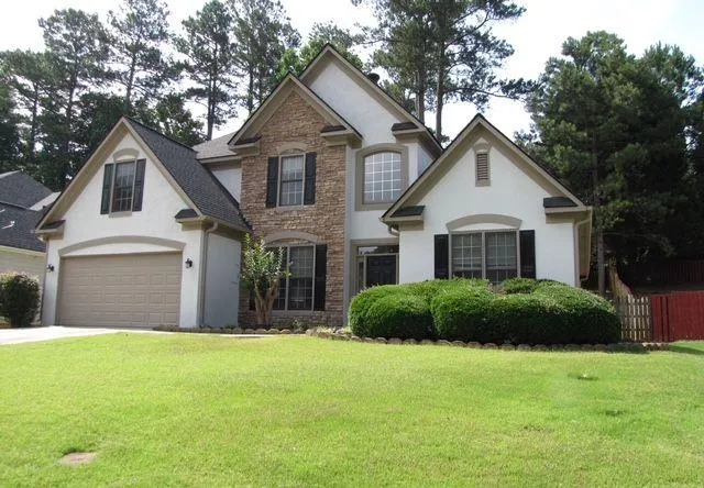 a front view of a house with a garden