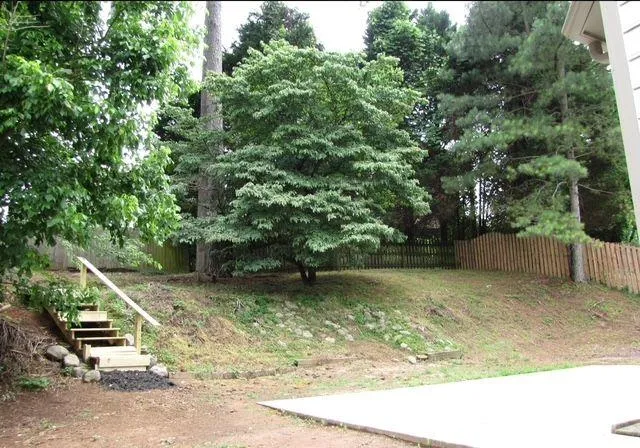 a roof deck with table and chairs under an umbrella