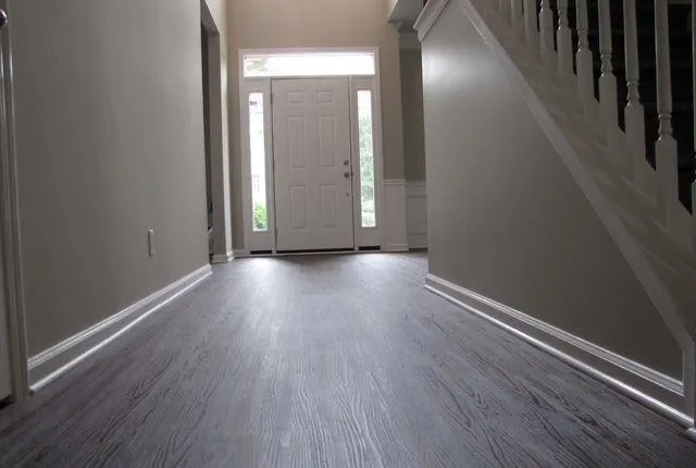 a view of hallway with wooden floor