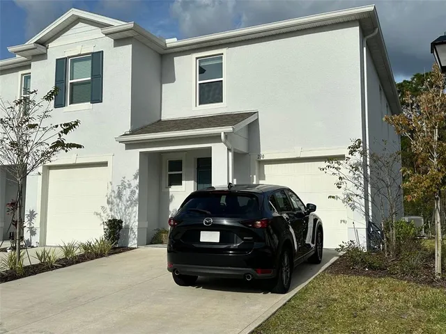 a black car parked in front of a white building