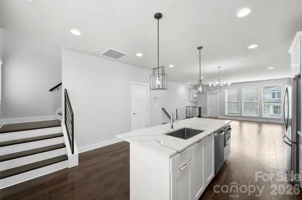 a kitchen with sink and refrigerator