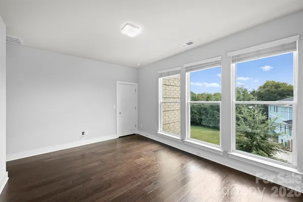 a view of room with window and wooden floor