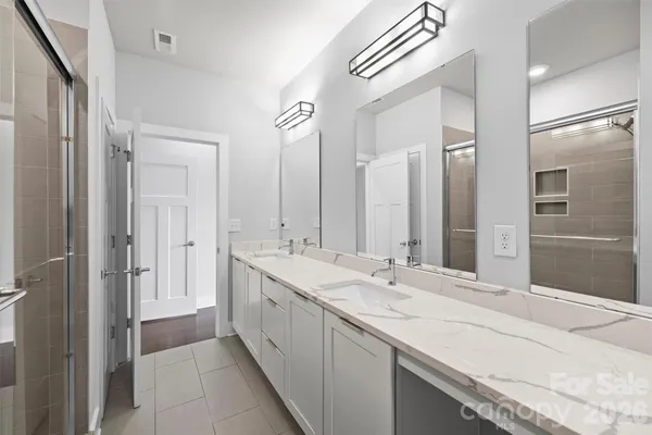 a spacious bathroom with a double vanity sink mirror and double