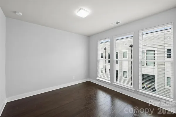 a view of wooden floor and windows in a room