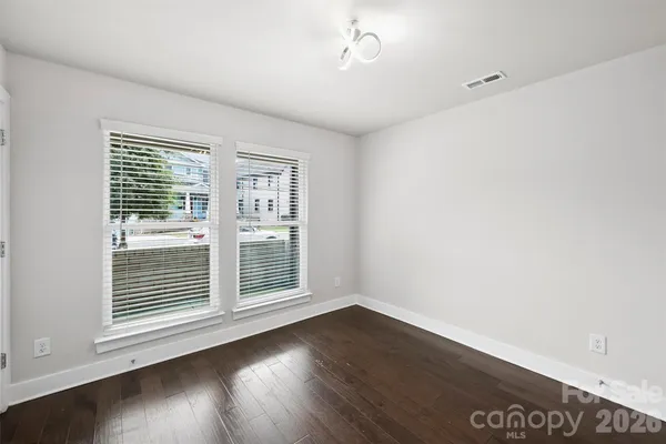 a view of wooden floor and windows in a room
