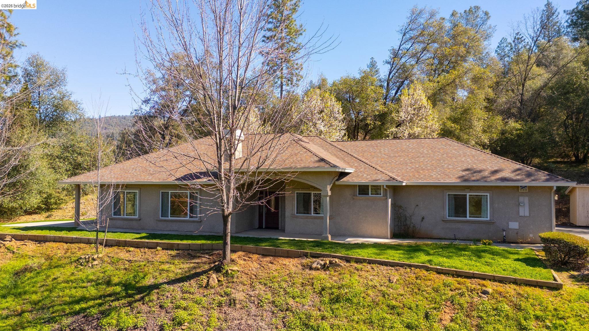 20245 Tuolumne Road North Tuolumne, CA 95379 - Photo 1 of 43 a front view of a house with a yard