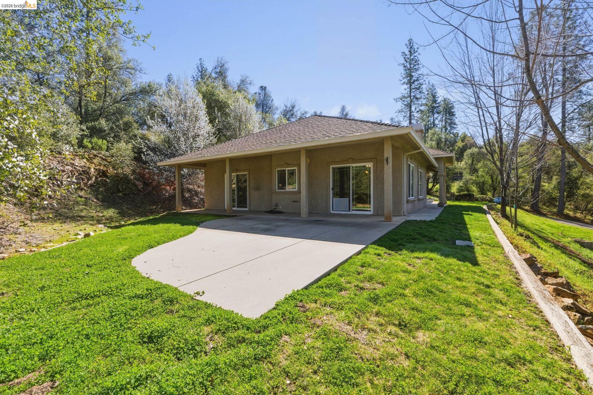 20245 Tuolumne Road North Tuolumne, CA 95379 - Photo 15 of 43 a view of a house with a yard
