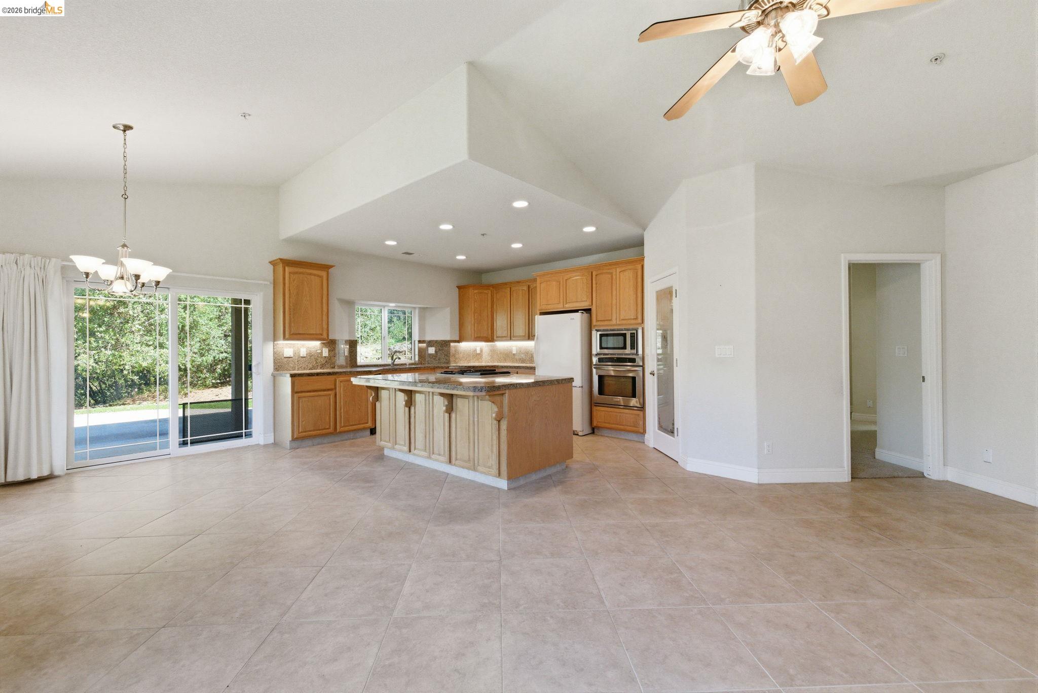 20245 Tuolumne Road North Tuolumne, CA 95379 - Photo 19 of 43 a view of kitchen with kitchen island a sink appliances and a counter top space