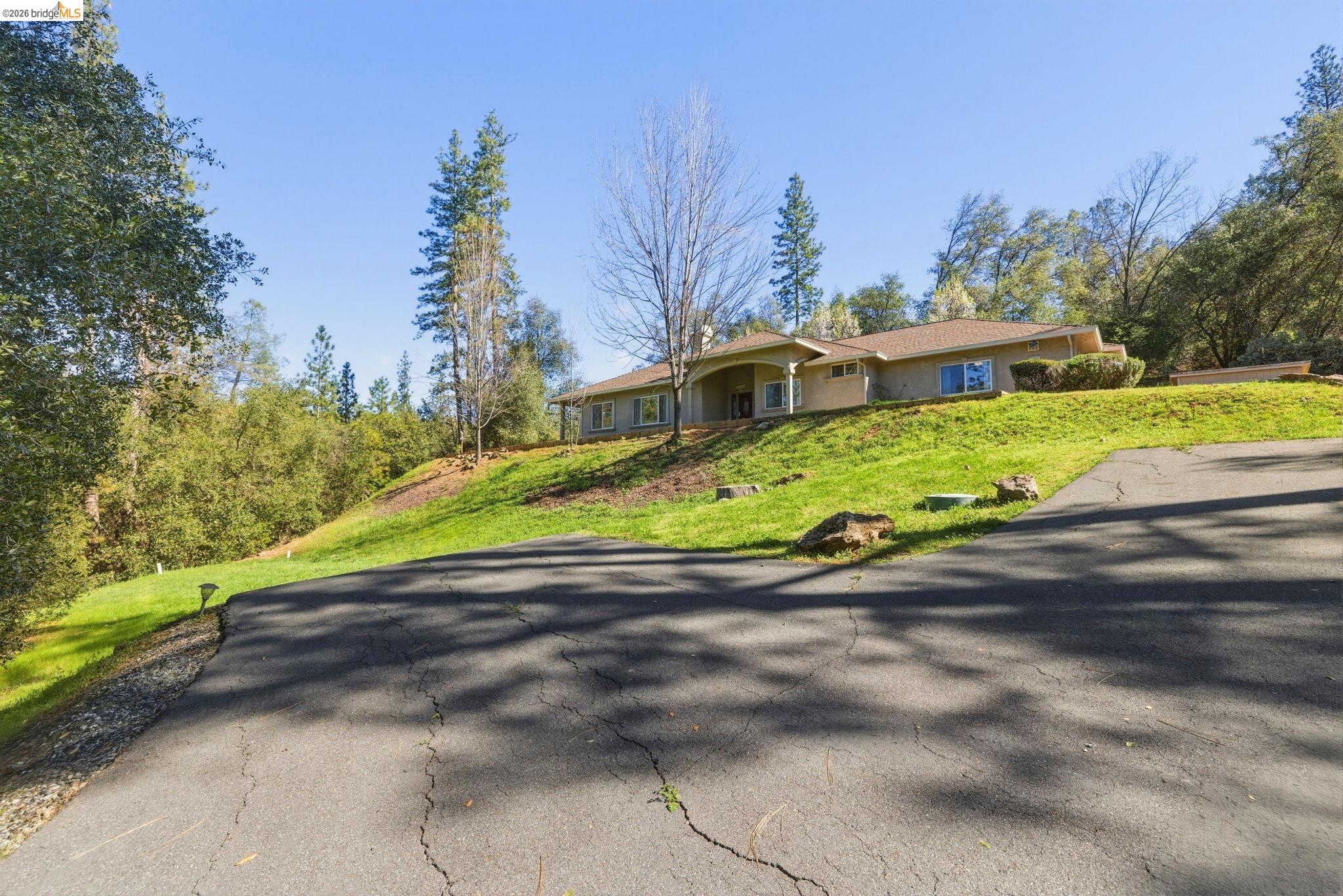 20245 Tuolumne Road North Tuolumne, CA 95379 - Photo 2 of 43 a view of a house with a yard