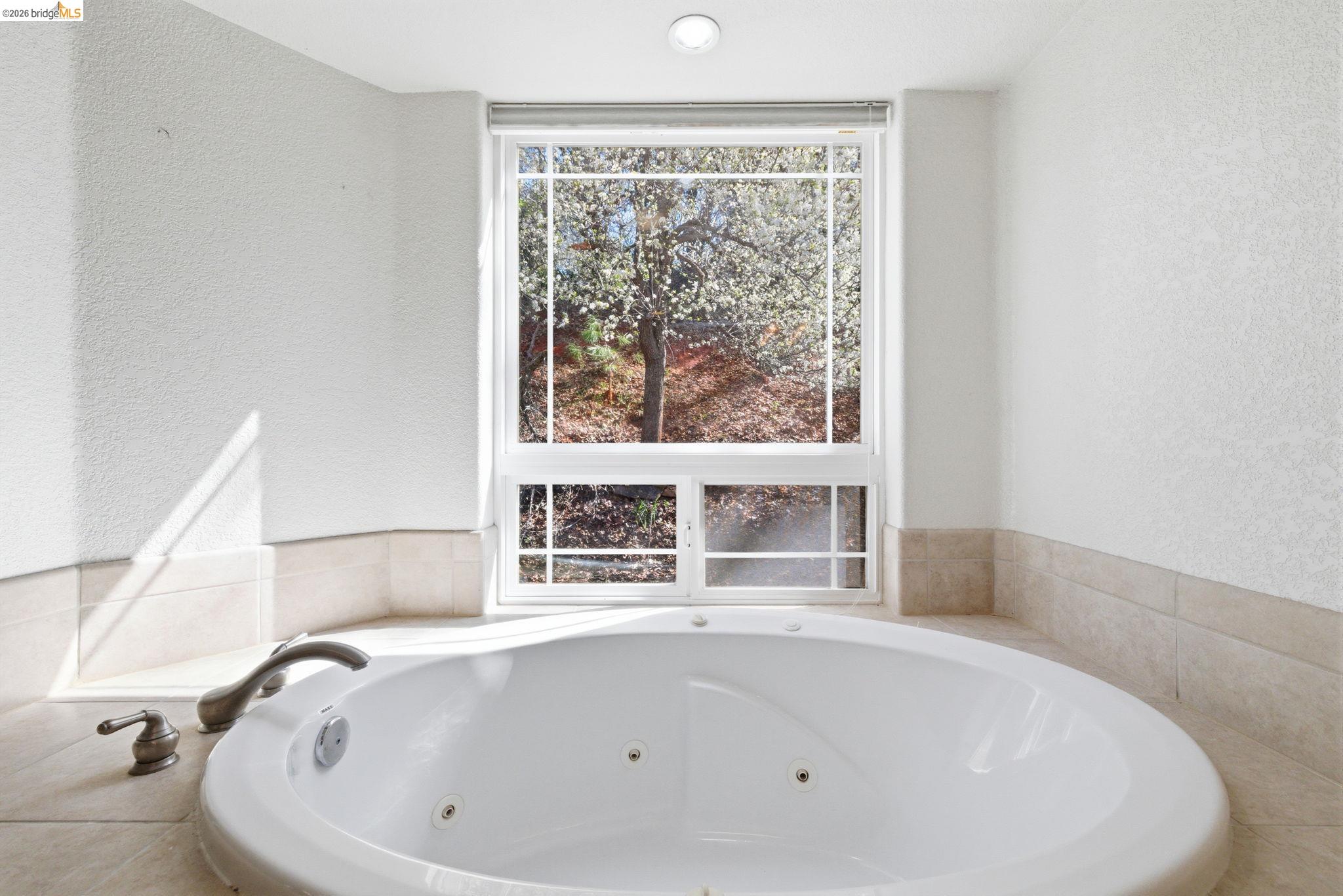20245 Tuolumne Road North Tuolumne, CA 95379 - Photo 23 of 43 a white bath tub sitting in a bathroom next to a window
