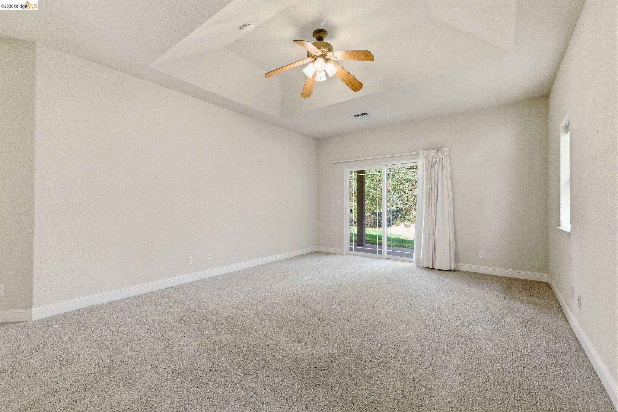 20245 Tuolumne Road North Tuolumne, CA 95379 - Photo 27 of 43 a view of a room with a ceiling fan and a window