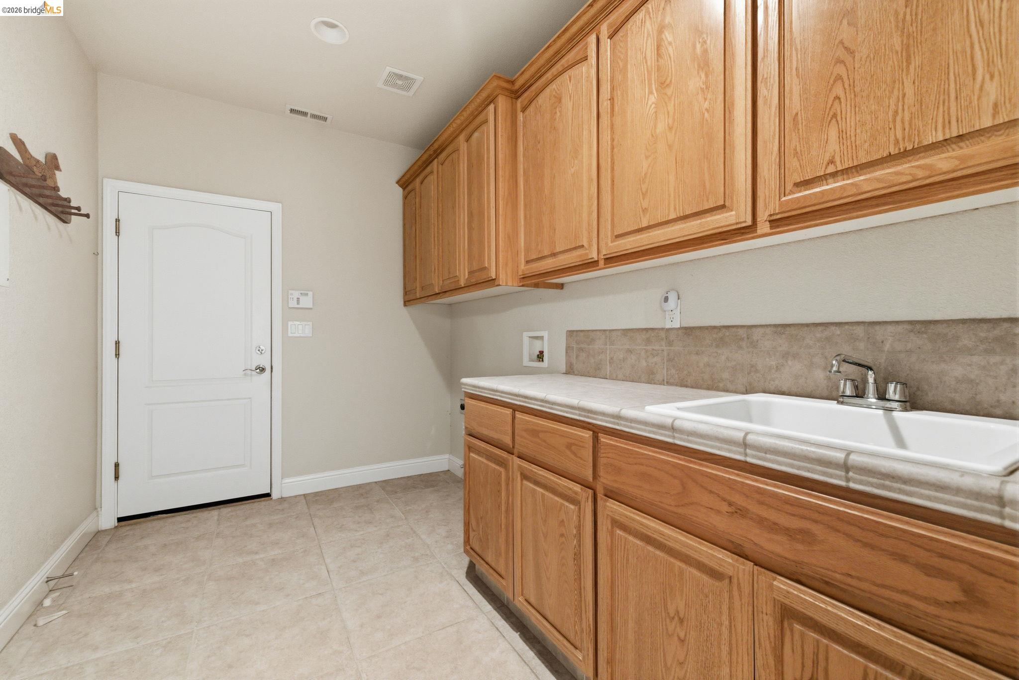 20245 Tuolumne Road North Tuolumne, CA 95379 - Photo 28 of 43 a kitchen with granite countertop white cabinets and sink