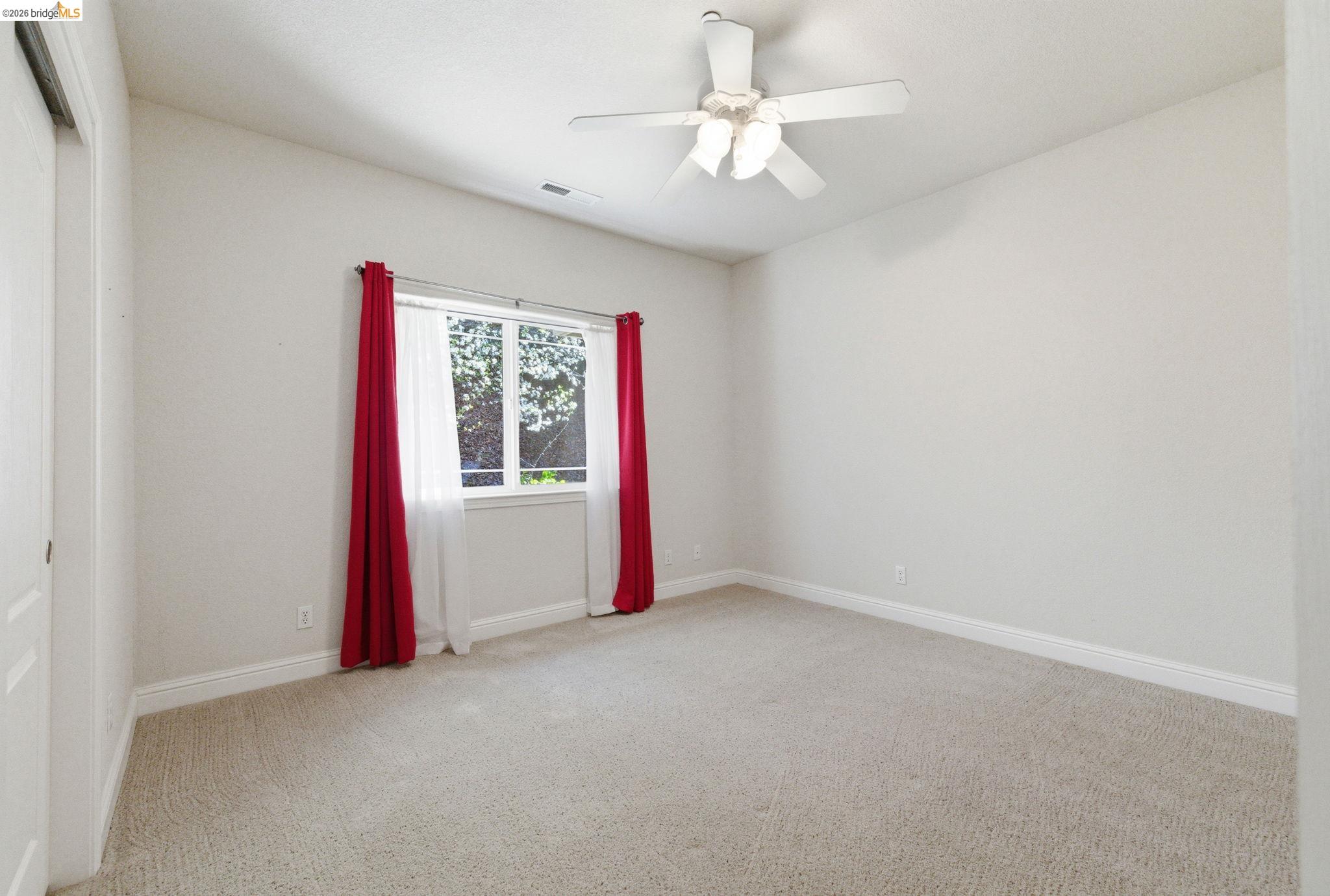 20245 Tuolumne Road North Tuolumne, CA 95379 - Photo 30 of 43 an empty room with windows and fan