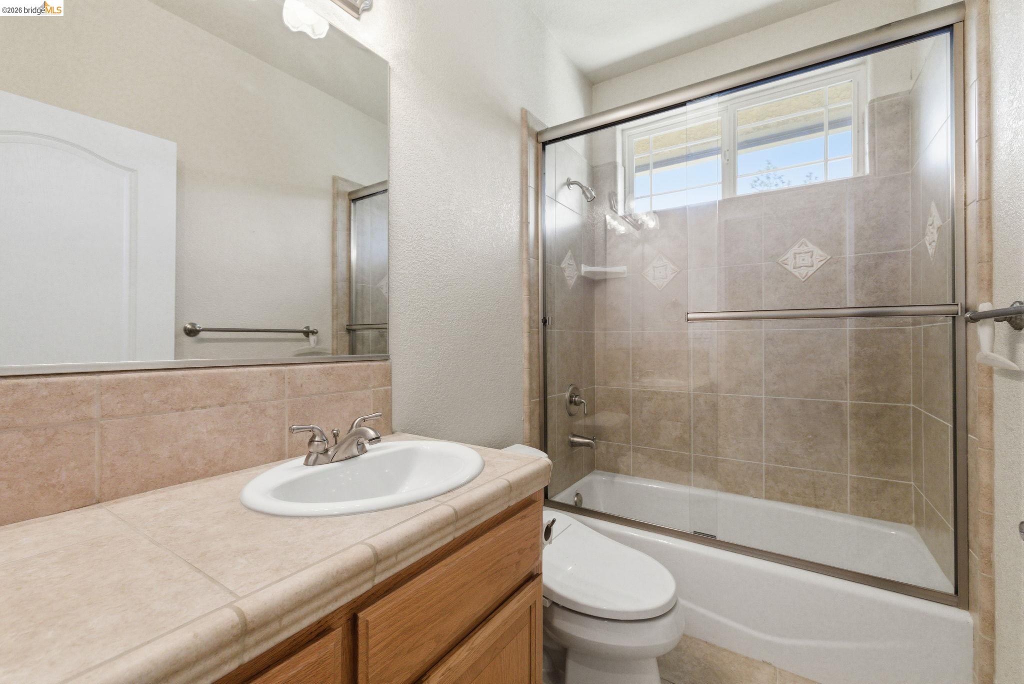 20245 Tuolumne Road North Tuolumne, CA 95379 - Photo 31 of 43 a bathroom with a granite countertop sink toilet and shower