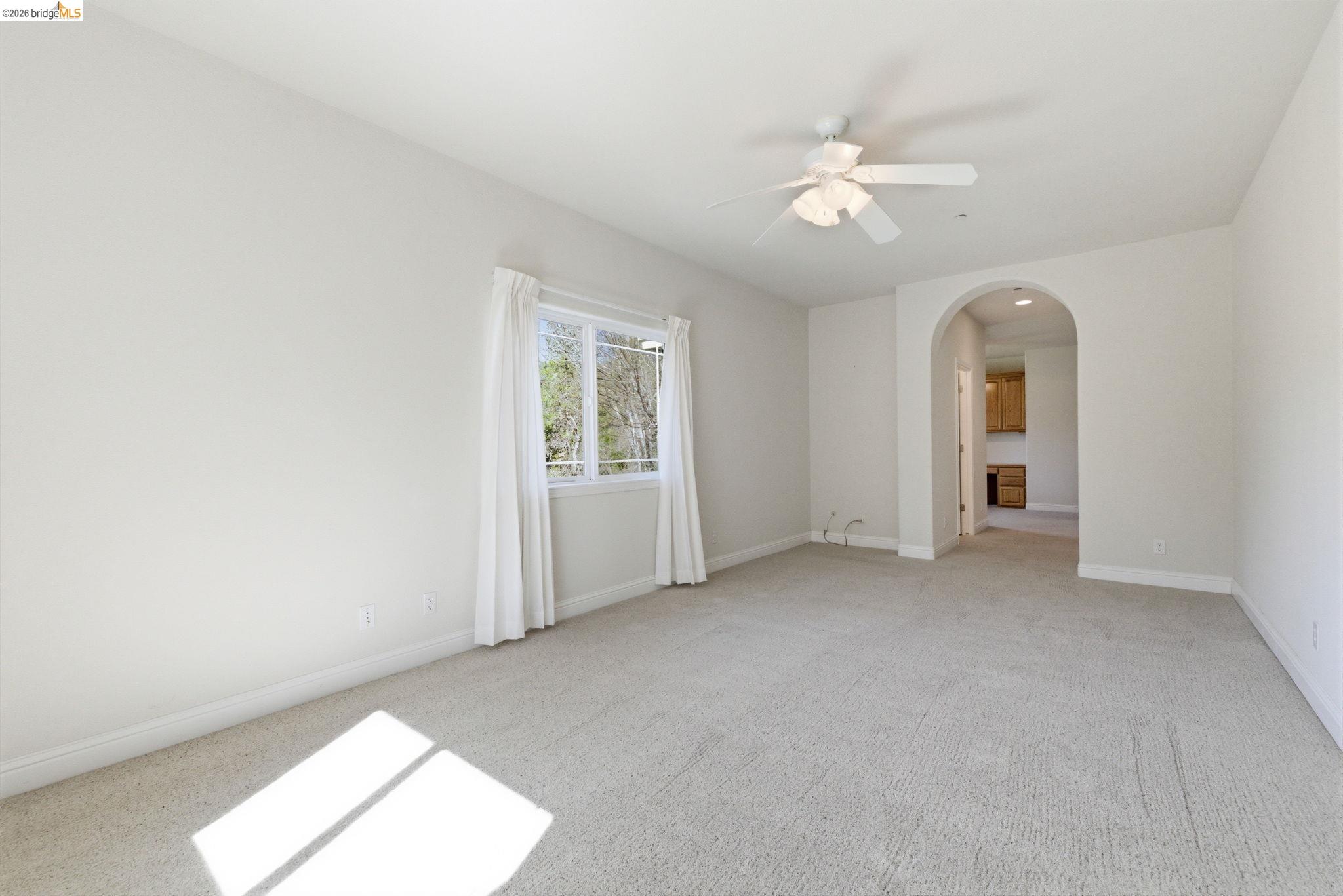 20245 Tuolumne Road North Tuolumne, CA 95379 - Photo 35 of 43 an empty room with chandelier fan and windows
