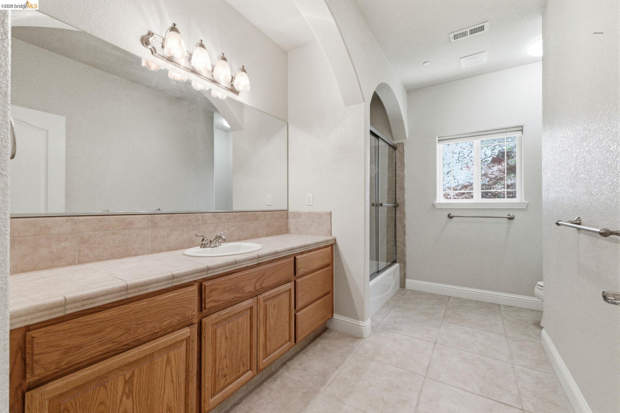 20245 Tuolumne Road North Tuolumne, CA 95379 - Photo 37 of 43 a bathroom with a sink a vanity and a mirror