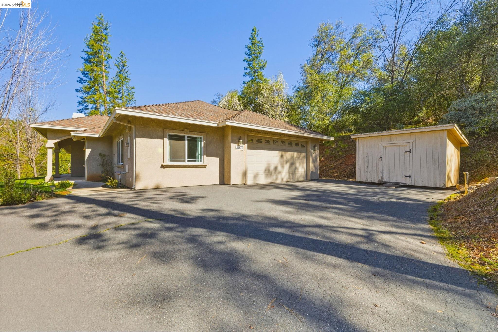 20245 Tuolumne Road North Tuolumne, CA 95379 - Photo 40 of 43 a view of a house with a yard and garage