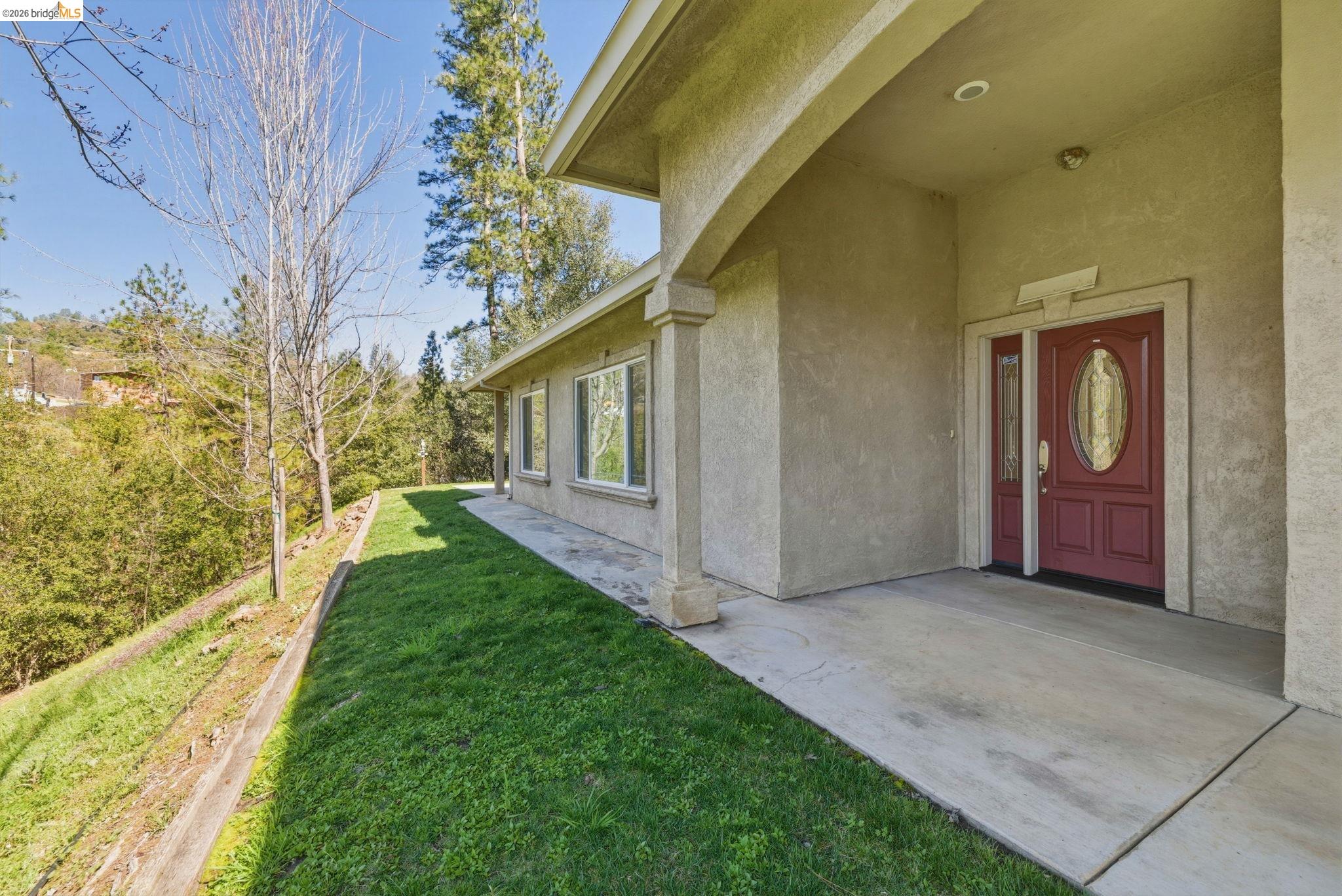 20245 Tuolumne Road North Tuolumne, CA 95379 - Photo 4 of 43 a view of an entrance to house with yard