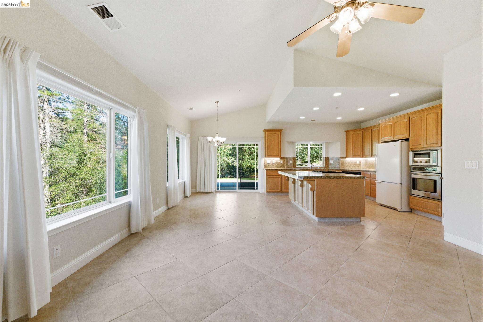 20245 Tuolumne Road North Tuolumne, CA 95379 - Photo 7 of 43 a view of kitchen with kitchen island and windows