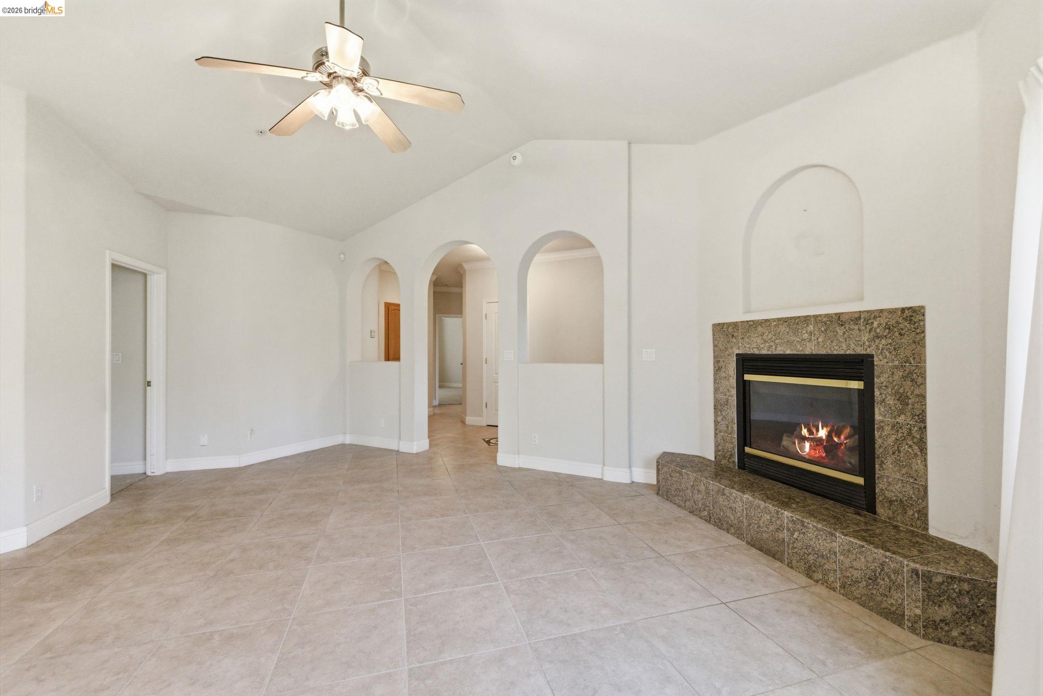 20245 Tuolumne Road North Tuolumne, CA 95379 - Photo 8 of 43 a view of an empty room with chandelier fan and fire place