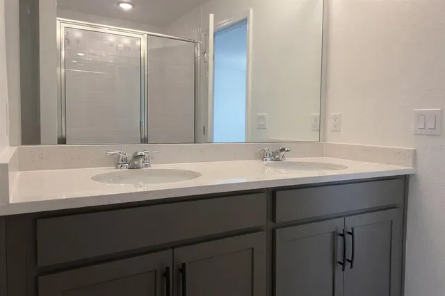a bathroom with a sink double vanity and a mirror