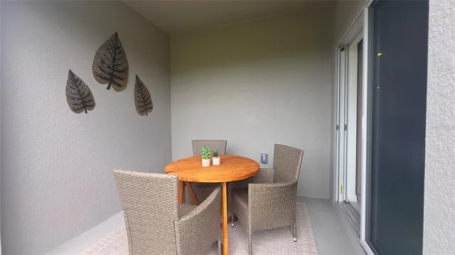 a view of a dining room with furniture and front door
