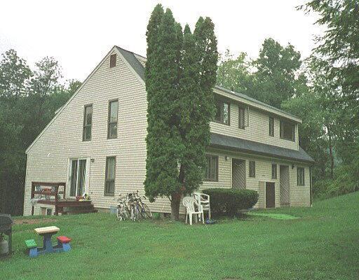 a front view of house with a garden and patio