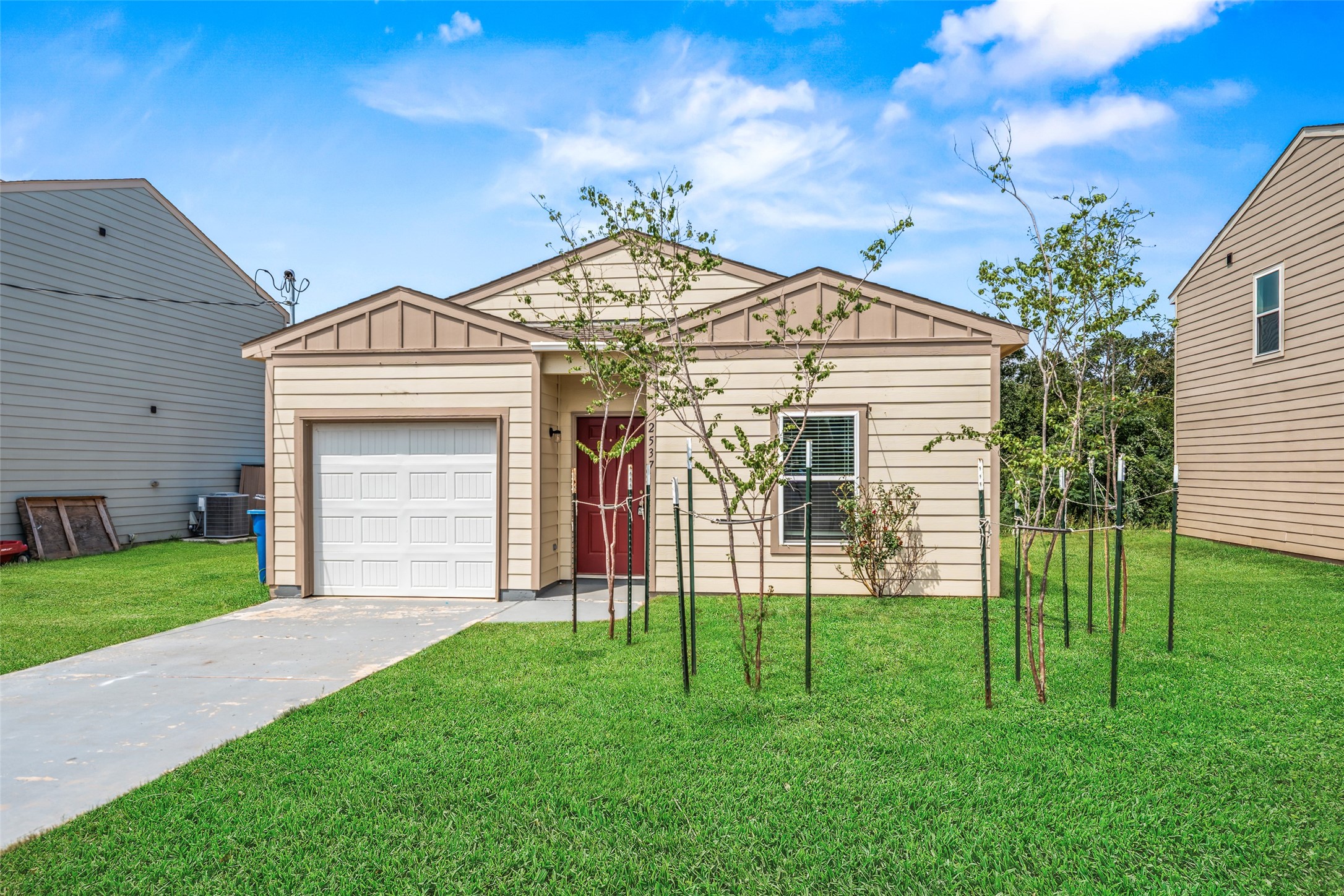 Inviting front view highlighting the home’s attractive exterior, attached garage, landscaped entry, and spacious front yard.