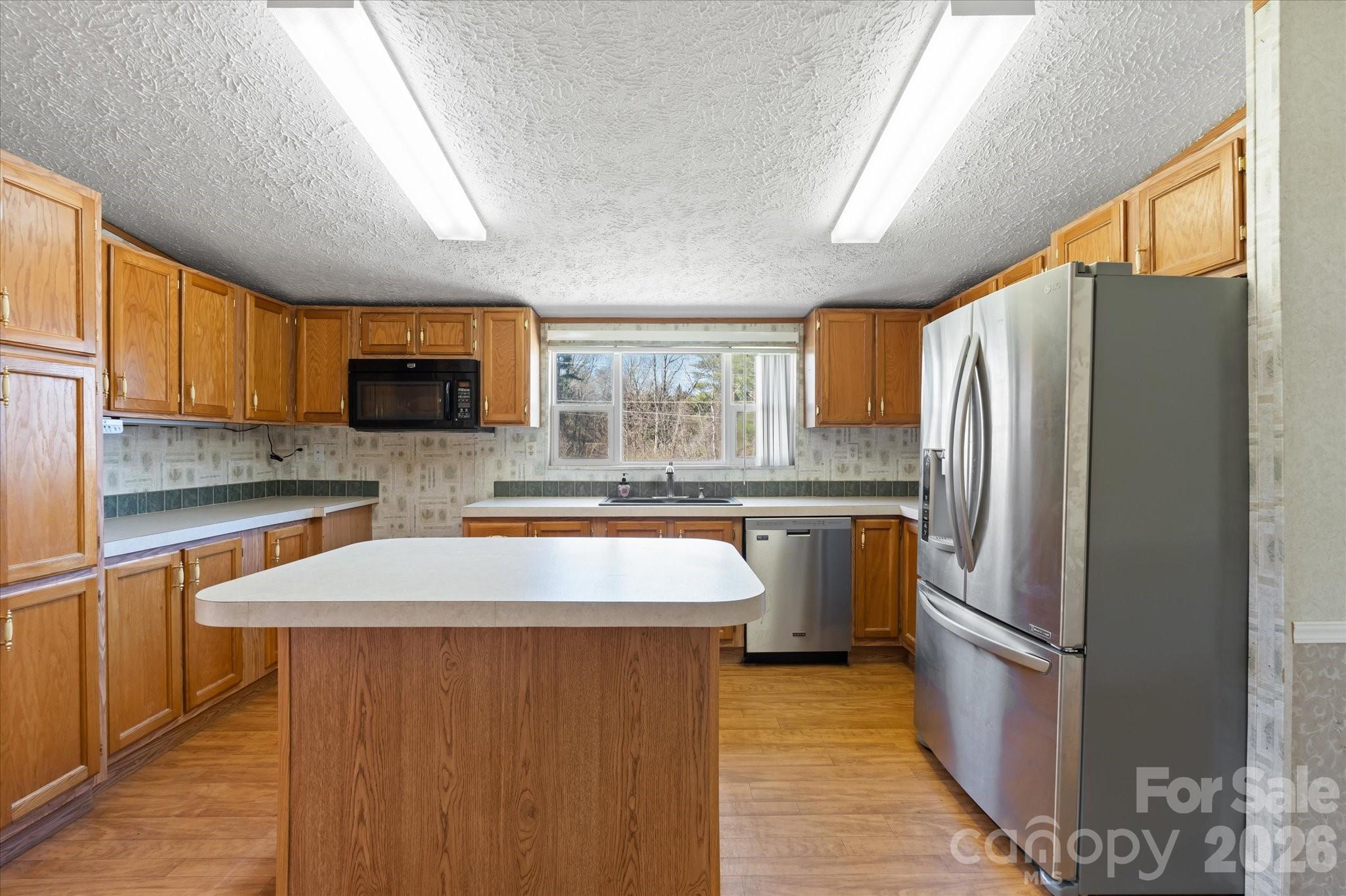 18 Ford Valley Road Weaverville, NC 28787 - Photo 11 of 37 a kitchen with stainless steel appliances a refrigerator stove microwave and sink
