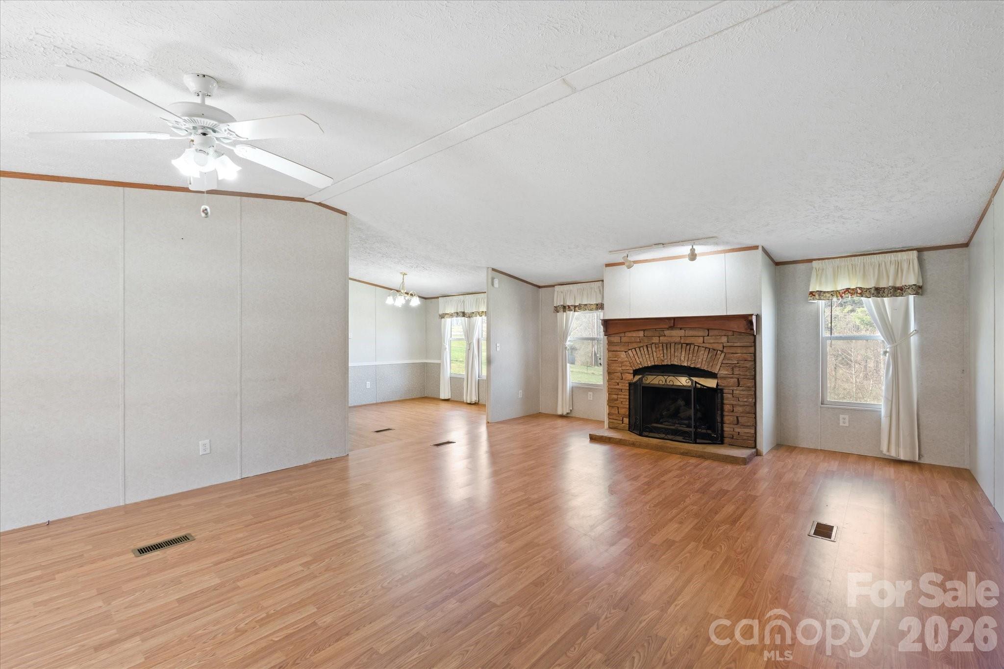 18 Ford Valley Road Weaverville, NC 28787 - Photo 5 of 37 a view of an empty room with wooden floor fireplace and a window