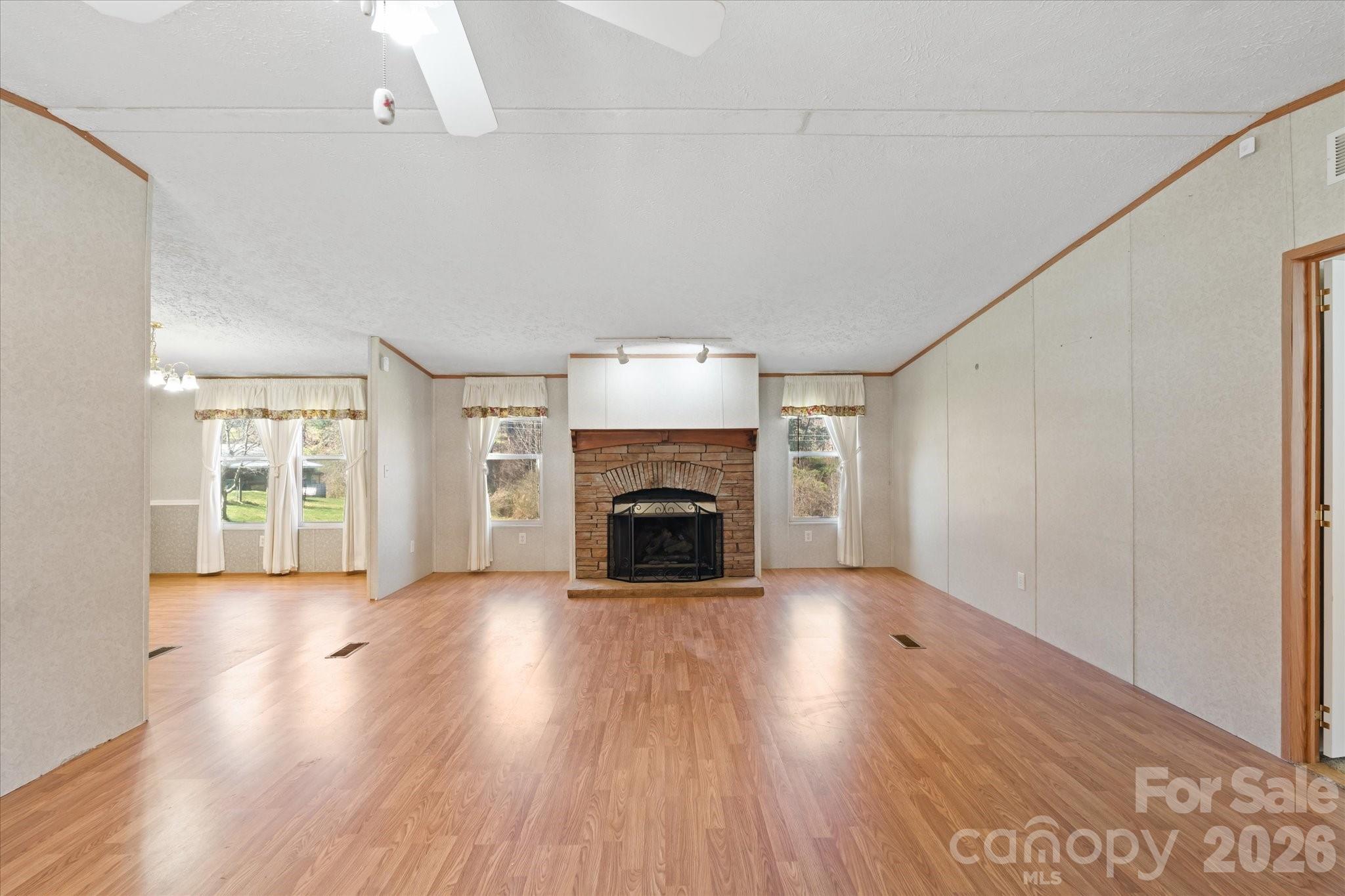 18 Ford Valley Road Weaverville, NC 28787 - Photo 7 of 37 a view of an empty room with a fireplace and a window