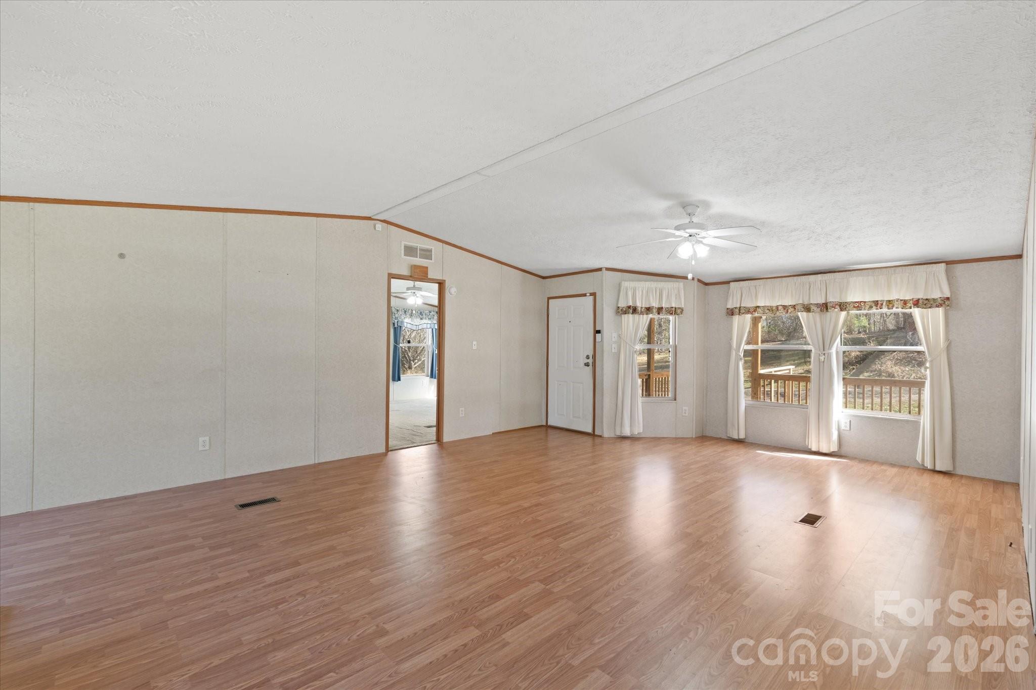 18 Ford Valley Road Weaverville, NC 28787 - Photo 8 of 37 a view of an empty room with wooden floor and a window