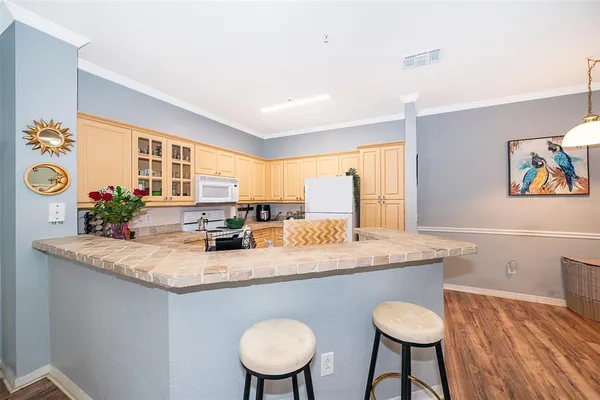 a room with granite countertop a sink and a stove