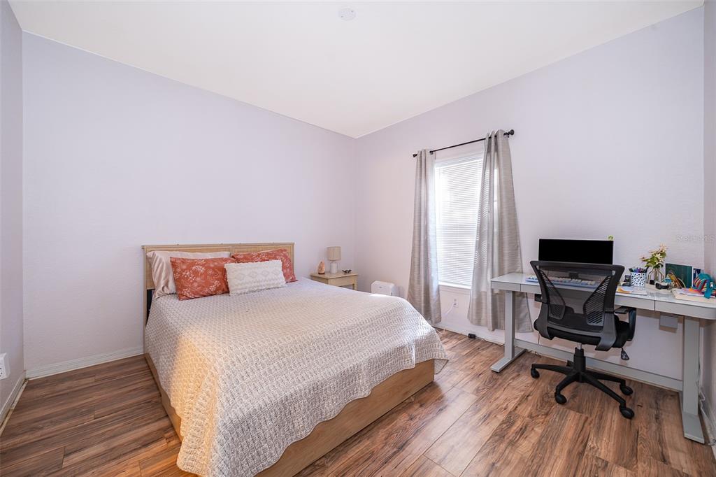 3707 Conroy Road, Unit 1715 Orlando, FL 32839 - Photo 14 of 20 a bedroom with a bed and a desk