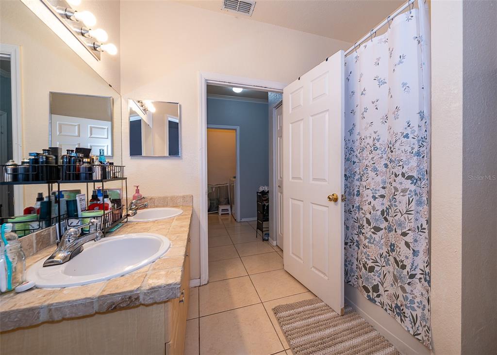 3707 Conroy Road, Unit 1715 Orlando, FL 32839 - Photo 15 of 20 a bathroom with a sink double vanity and a mirror