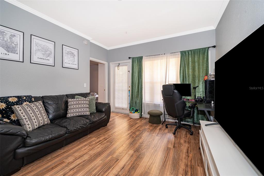 3707 Conroy Road, Unit 1715 Orlando, FL 32839 - Photo 5 of 20 a living room with furniture and a flat screen tv