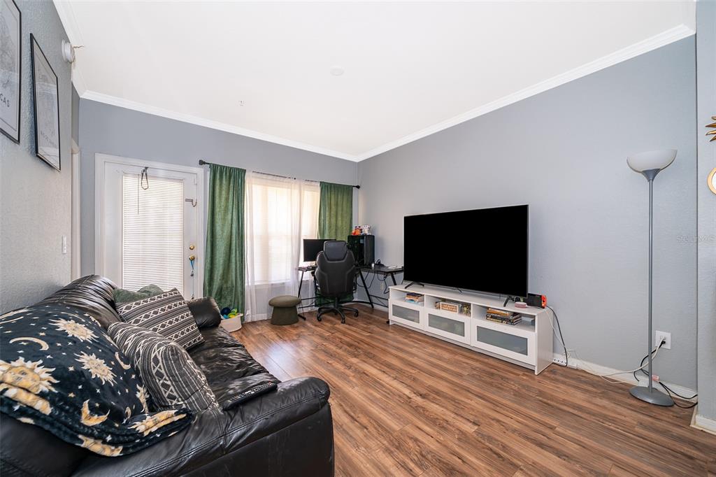 3707 Conroy Road, Unit 1715 Orlando, FL 32839 - Photo 6 of 20 a living room with furniture and a flat screen tv