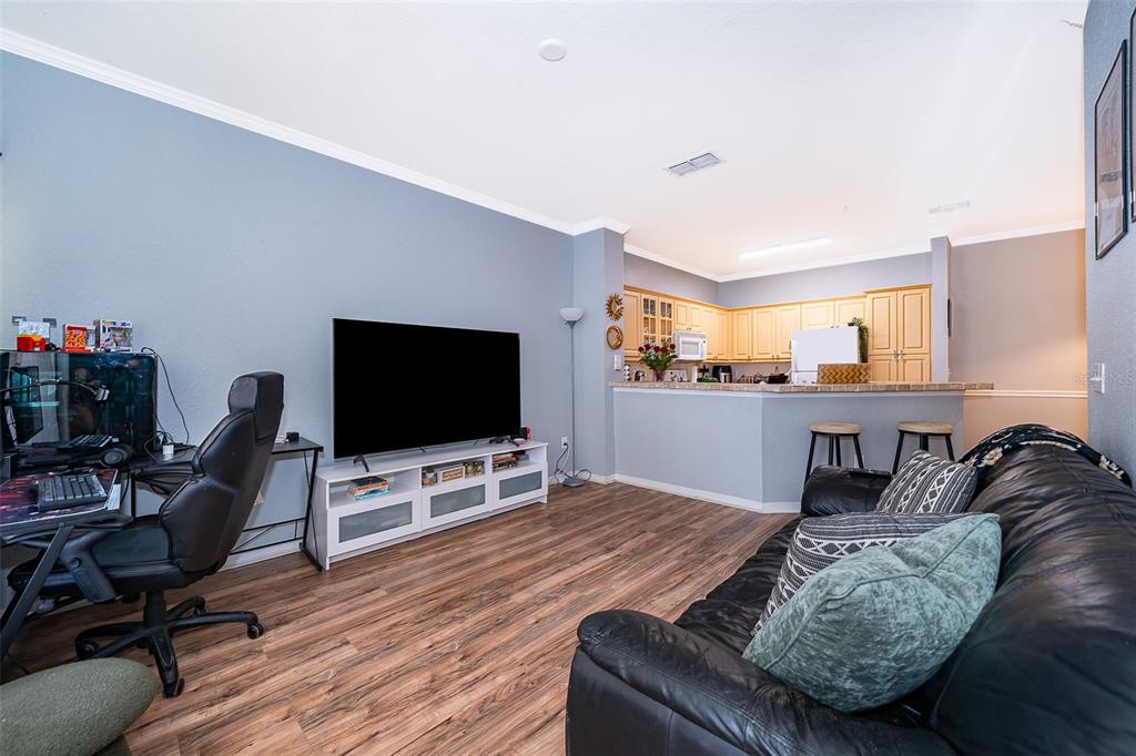 3707 Conroy Road, Unit 1715 Orlando, FL 32839 - Photo 7 of 20 a living room with furniture and a flat screen tv