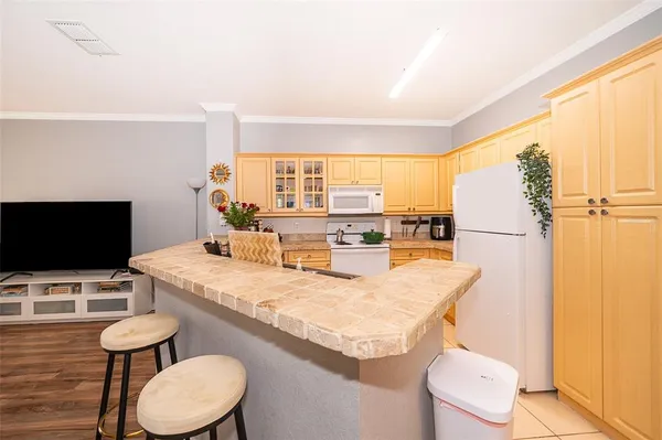 a kitchen with a table chairs and a refrigerator